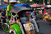 Riding the becak, the local cycle rickshaws in Malioboro street Yogyakarta. 